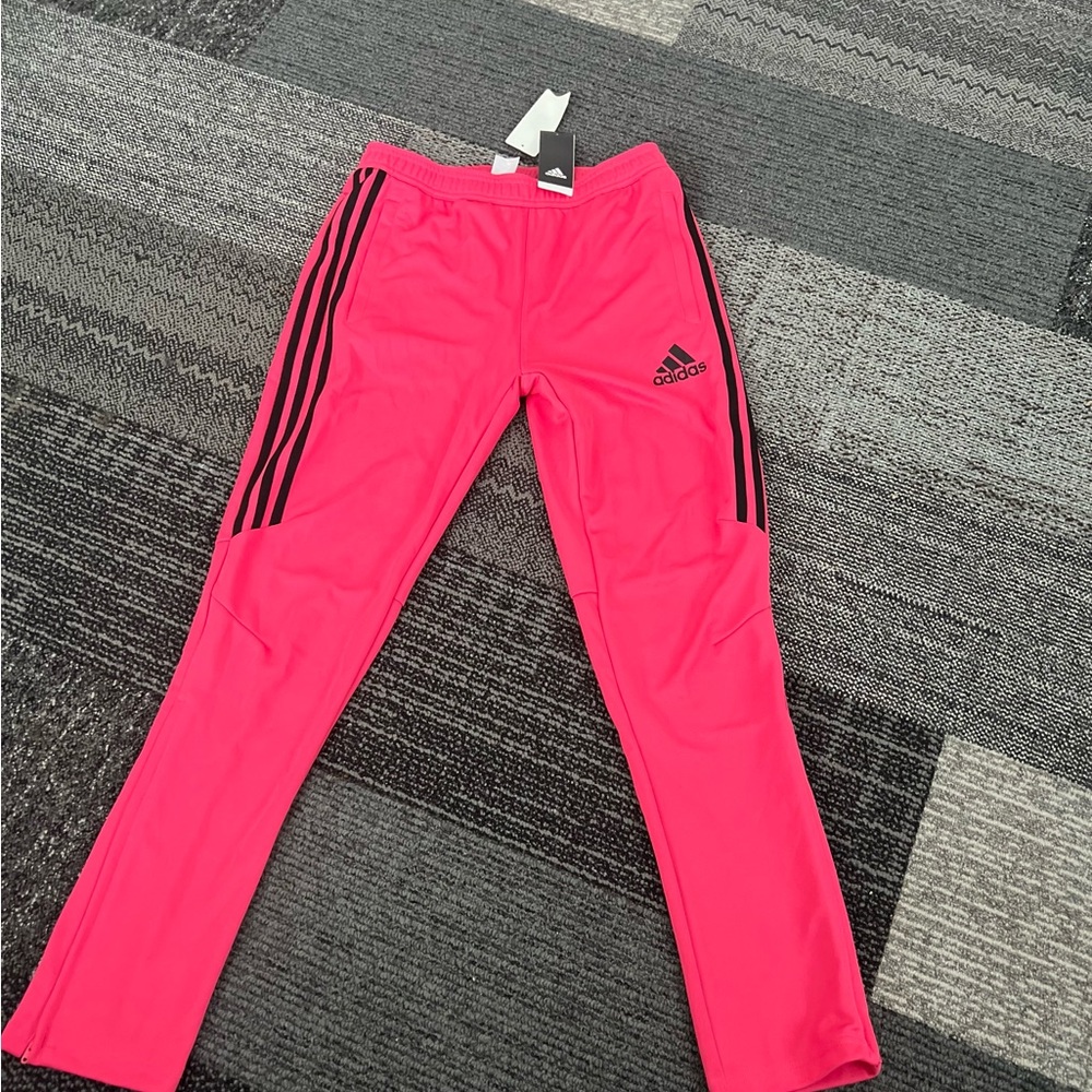 Adidas pants with zipper on the legs. Brand new with tags.